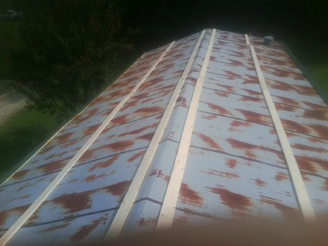 Rusted metal roof panels with new wood purlins before replacement — Storm Damage Roof Repair in Netawaka by Roofing Brothers