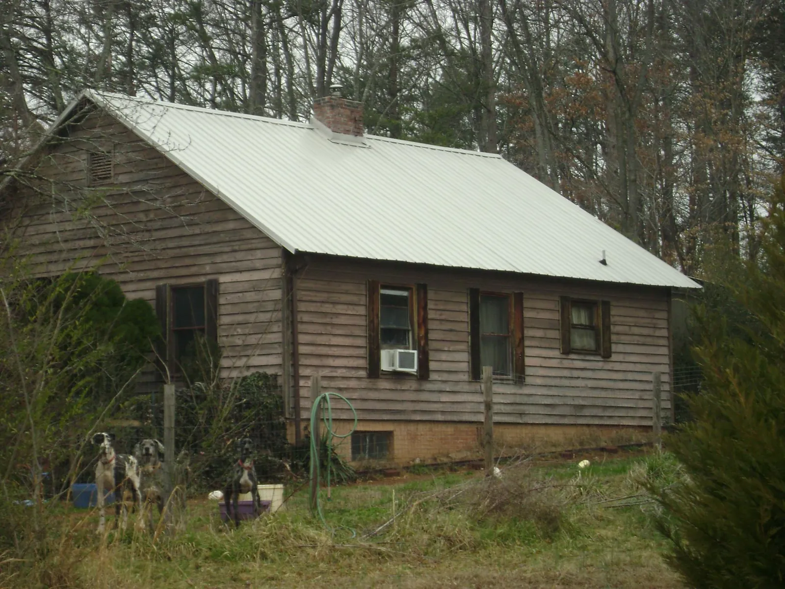 White metal roof on an old wood sided farmhouse, from a Metal Roof Installation job in Netawaka
